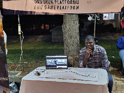 EMU Game Platform booth at an evening event